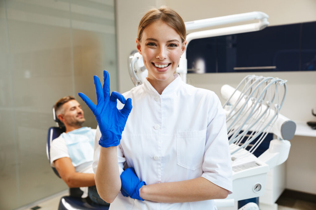 woman doctor in medical dentist center showing okay gesture.